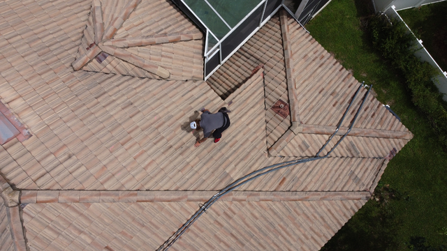 Man Inspecting Roof